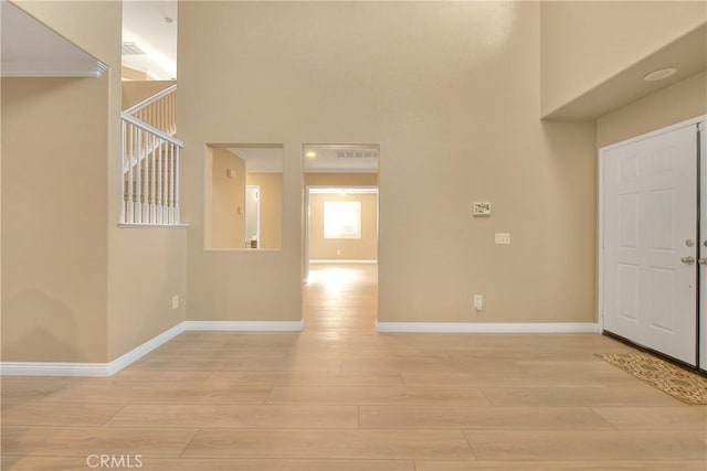 12415 Brianwood Dr, Riverside, CA 92503 - entryway featuring light wood-style flooring, a high ceiling, and baseboards