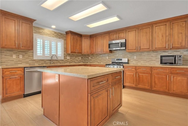 12415 Brianwood Dr, Riverside, CA 92503 - kitchen with stainless steel appliances, light wood-style floors, brown cabinets, a center island, and backsplash