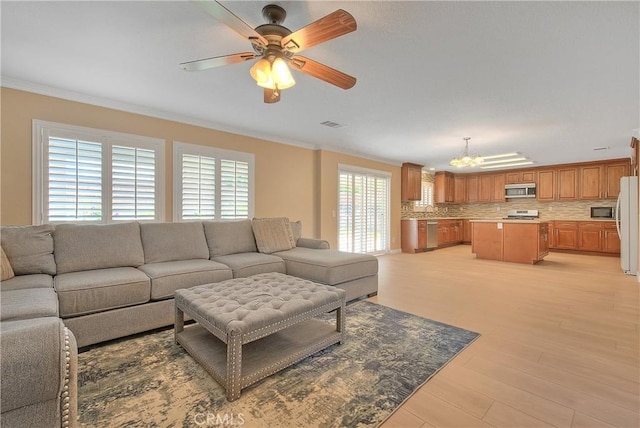 12415 Brianwood Dr, Riverside, CA 92503 - living area featuring a chandelier, crown molding, a ceiling fan, and light wood-type flooring
