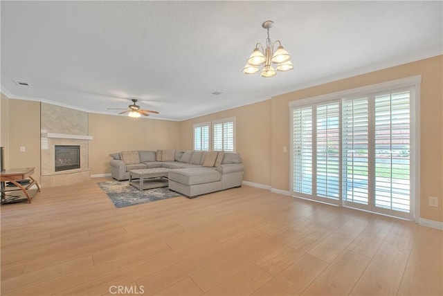 12415 Brianwood Dr, Riverside, CA 92503 - living room featuring light wood-style floors, a ceiling fan, baseboards, a chandelier, and ornamental molding