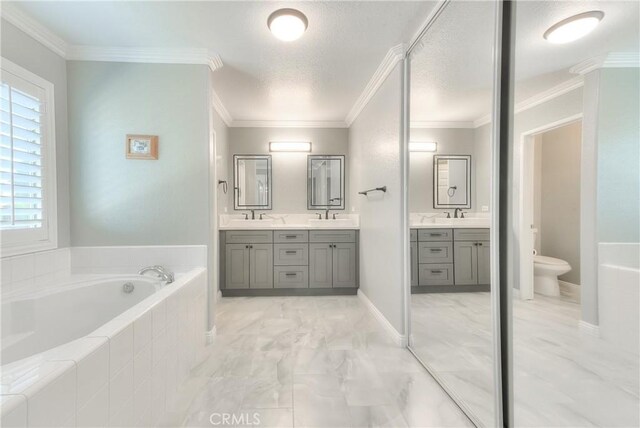12415 Brianwood Dr, Riverside, CA 92503 - bathroom featuring toilet, a bath, double vanity, marble finish floors, and ornamental molding