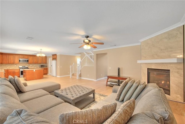 12415 Brianwood Dr, Riverside, CA 92503 - living area with stairs, a ceiling fan, baseboards, ornamental molding, and light wood-style floors