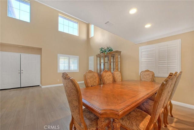12415 Brianwood Dr, Riverside, CA 92503 - dining space with light wood-type flooring, baseboards, recessed lighting, and a high ceiling