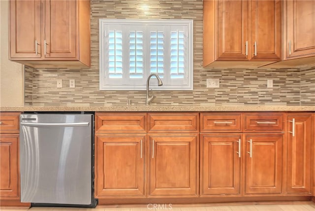 12415 Brianwood Dr, Riverside, CA 92503 - kitchen with dishwasher, light stone counters, backsplash, and brown cabinets