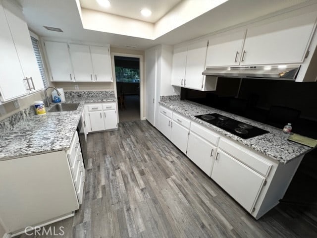 108 Limestone Rd, Claremont, CA 91711 - kitchen with a sink, under cabinet range hood, a raised ceiling, black electric cooktop, and wood finished floors