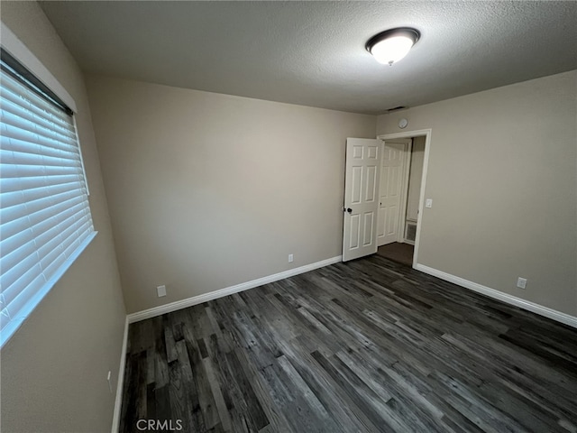 108 Limestone Rd, Claremont, CA 91711 - spare room featuring dark wood finished floors, baseboards, and a textured ceiling