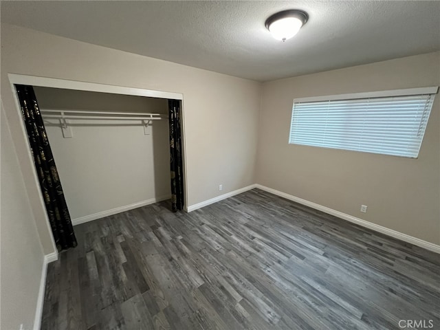 108 Limestone Rd, Claremont, CA 91711 - unfurnished bedroom with dark wood-style flooring, a closet, baseboards, and a textured ceiling