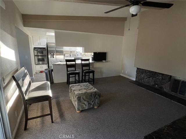 108 Limestone Rd, Claremont, CA 91711 - carpeted living room with ceiling fan, vaulted ceiling, and a fireplace