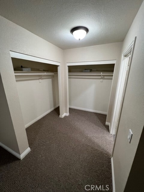 108 Limestone Rd, Claremont, CA 91711 - unfurnished bedroom with a textured ceiling, carpet flooring, baseboards, and multiple closets