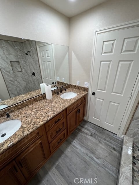 108 Limestone Rd, Claremont, CA 91711 - full bathroom with tiled shower, double vanity, and wood finished floors