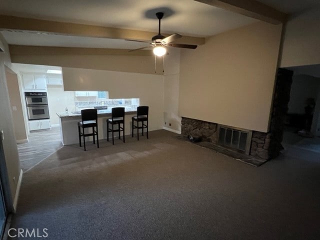 108 Limestone Rd, Claremont, CA 91711 - dining area featuring a fireplace, beamed ceiling, ceiling fan, and carpet