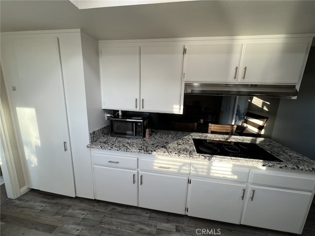 108 Limestone Rd, Claremont, CA 91711 - kitchen featuring stainless steel microwave, under cabinet range hood, black electric cooktop, white cabinets, and dark wood-type flooring