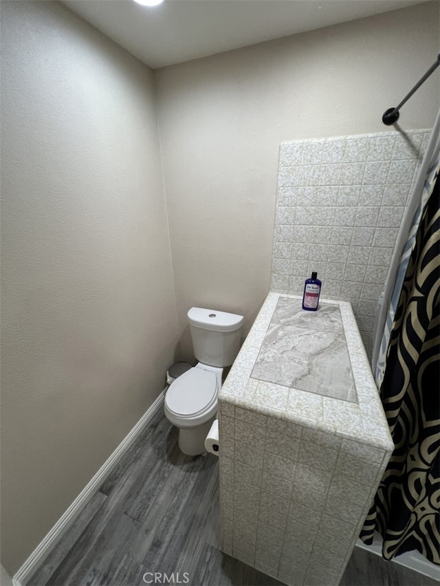 108 Limestone Rd, Claremont, CA 91711 - bathroom with toilet, wood finished floors, a shower with curtain, and baseboards