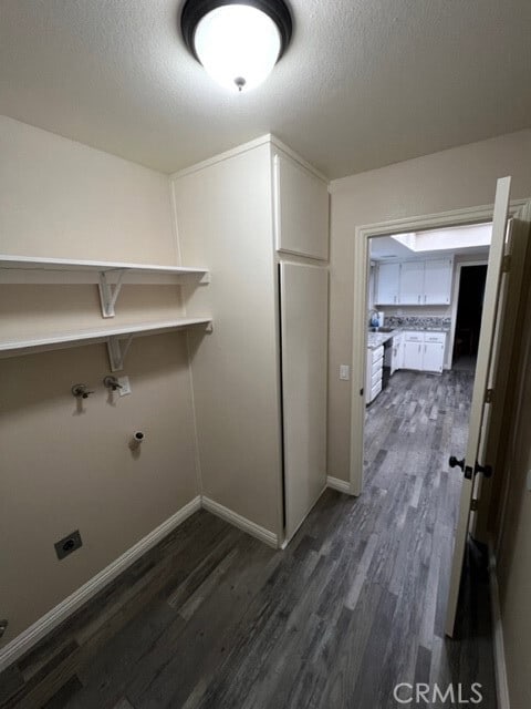 108 Limestone Rd, Claremont, CA 91711 - laundry room with dark wood finished floors, baseboards, and a textured ceiling