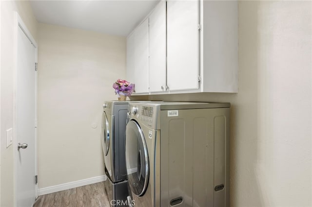 4950 N Treanor Ave, Covina, CA 91724 - laundry area with independent washer and dryer, cabinet space, baseboards, and light wood finished floors