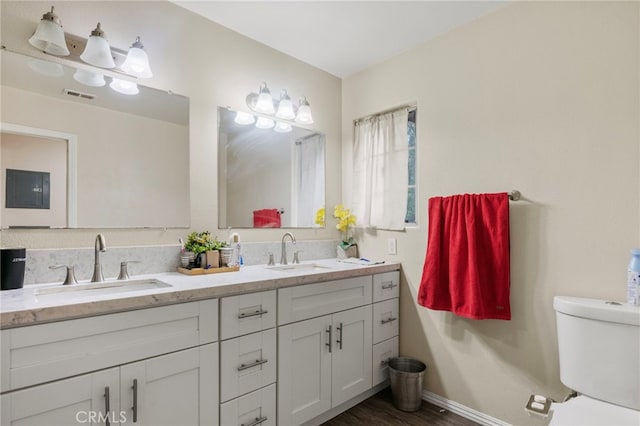 4950 N Treanor Ave, Covina, CA 91724 - full bath with double vanity, toilet, baseboards, and wood finished floors