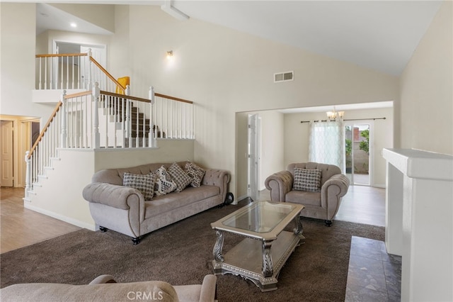 4950 N Treanor Ave, Covina, CA 91724 - living room with high vaulted ceiling, a chandelier, stairs, and wood finished floors