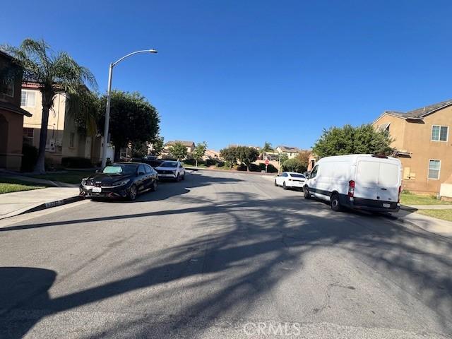 3762 Segovia Dr, Perris, CA 92571 - view of asphalt street with sidewalks, street lighting, curbs, and a residential view