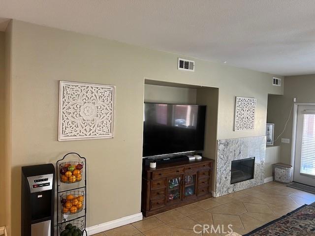 3762 Segovia Dr, Perris, CA 92571 - living room featuring a premium fireplace, tile patterned floors, and baseboards