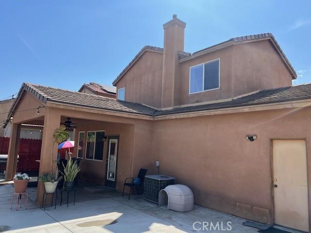 3762 Segovia Dr, Perris, CA 92571 - rear view of house with a patio area, a ceiling fan, a chimney, and central AC unit