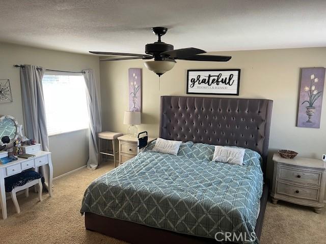 3762 Segovia Dr, Perris, CA 92571 - bedroom with light colored carpet and ceiling fan