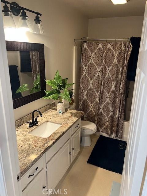 3762 Segovia Dr, Perris, CA 92571 - bathroom featuring vanity, shower / bath combination with curtain, and toilet
