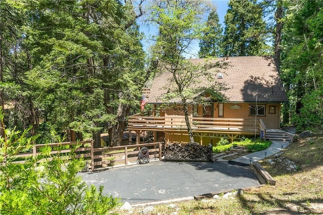 1213 Jungfrau Dr, Crestline, CA 92325 - rear view of house featuring a wooden deck and roof with shingles