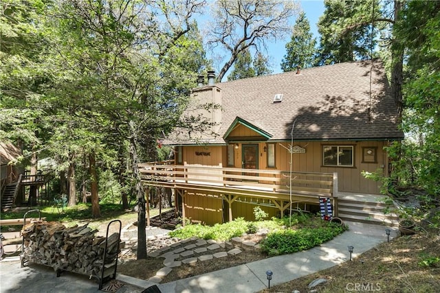 1213 Jungfrau Dr, Crestline, CA 92325 - view of front of property featuring stairway, roof with shingles, a chimney, and a deck