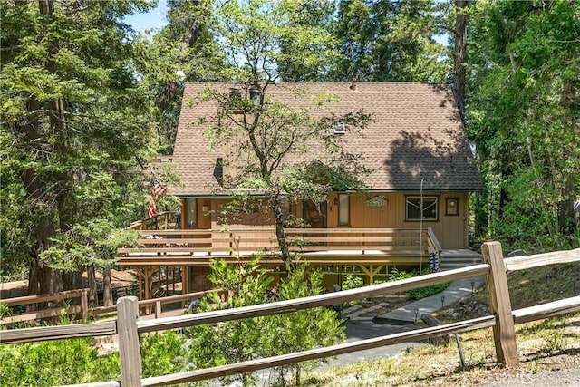 1213 Jungfrau Dr, Crestline, CA 92325 - view of front facade with a shingled roof and a wooden deck