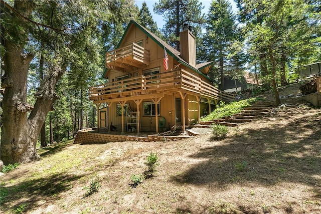 1213 Jungfrau Dr, Crestline, CA 92325 - rear view of property featuring a chimney, stairway, and a deck