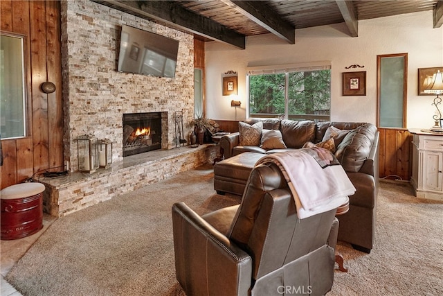 1213 Jungfrau Dr, Crestline, CA 92325 - living area featuring wood walls, carpet flooring, a fireplace, a wood ceiling with exposed beams, and wainscoting