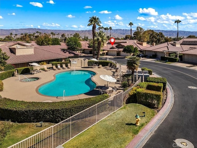 41810 Woodhaven Dr E, Palm Desert, CA 92211 - community pool with a hot tub, a patio, a residential view, and a mountain view