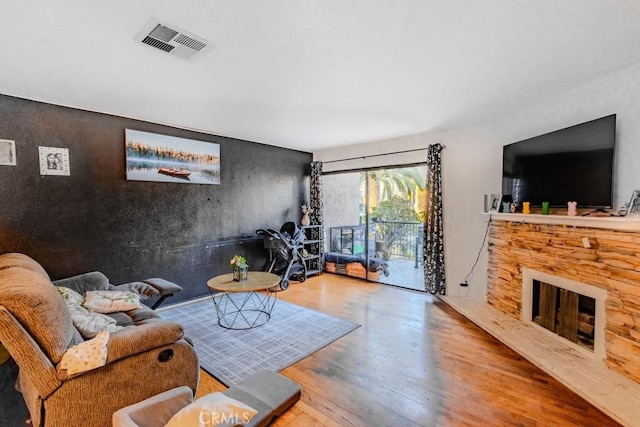 1052 W Ralston St, Ontario, CA 91762 - living room featuring wood finished floors and a fireplace
