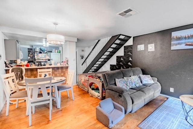 1052 W Ralston St, Ontario, CA 91762 - living area featuring stairs and light wood-type flooring