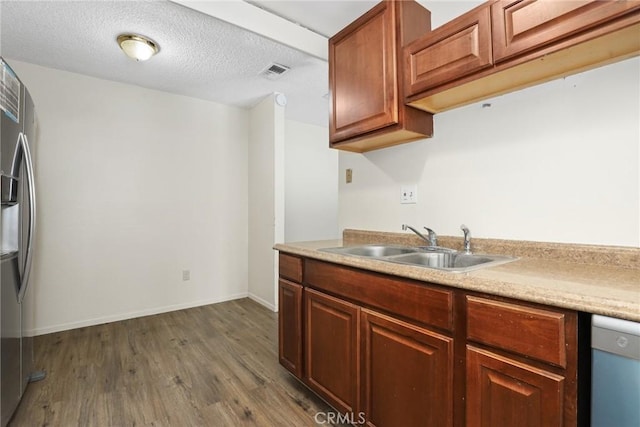 12828 Ramona Blvd Unit 54, Baldwin Park, CA 91706 - kitchen with freestanding refrigerator, dishwashing machine, a sink, dark wood-style flooring, and light countertops