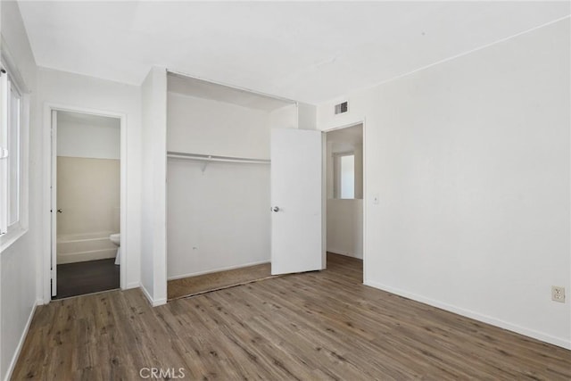 12828 Ramona Blvd Unit 54, Baldwin Park, CA 91706 - unfurnished bedroom with wood finished floors, baseboards, and a closet