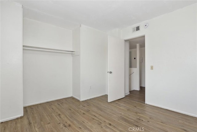 12828 Ramona Blvd Unit 54, Baldwin Park, CA 91706 - unfurnished bedroom with wood finished floors, baseboards, and a closet