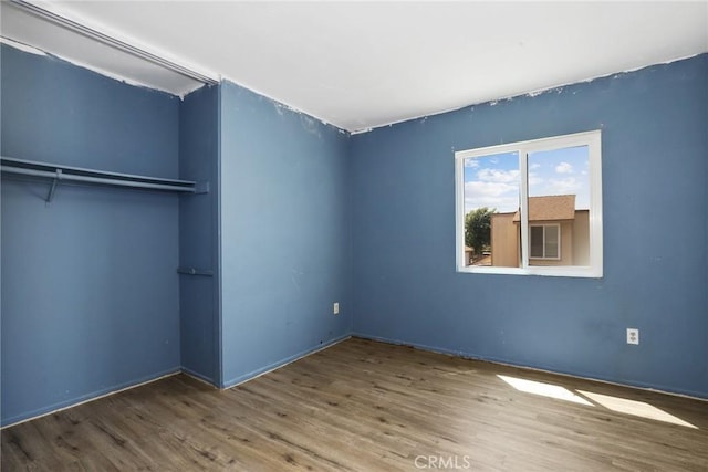 12828 Ramona Blvd Unit 54, Baldwin Park, CA 91706 - unfurnished bedroom with wood finished floors, baseboards, and a closet
