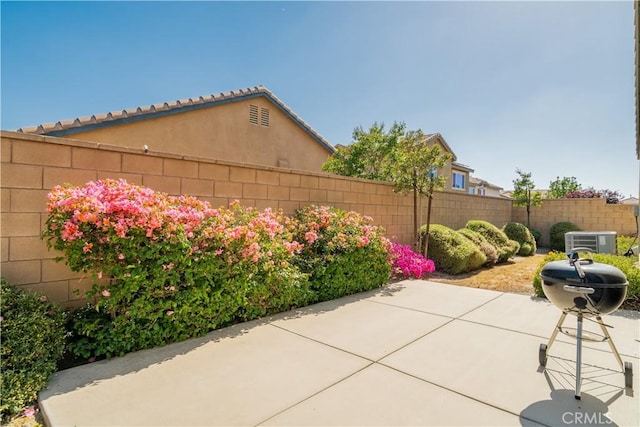 15345 Chive Ln, Fontana, CA 92336 - fenced backyard with a patio area and central air condition unit