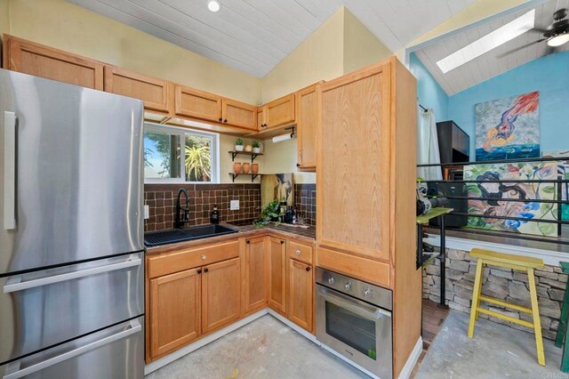2042 Pheasant Run, Fallbrook, CA 92028 - kitchen with appliances with stainless steel finishes, a skylight, unfinished concrete flooring, lofted ceiling, and tile countertops