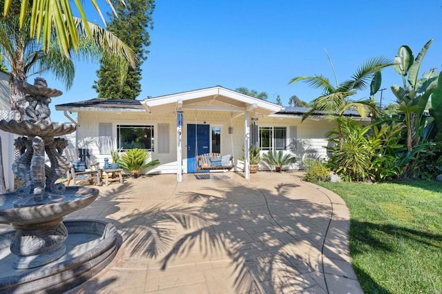 2042 Pheasant Run, Fallbrook, CA 92028 - ranch-style house with concrete block siding, a front yard, a patio area, and solar panels