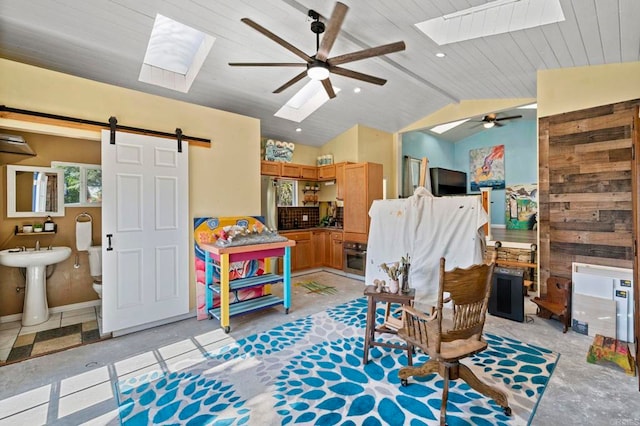 2042 Pheasant Run, Fallbrook, CA 92028 - living room with a skylight, a barn door, ceiling fan, and lofted ceiling