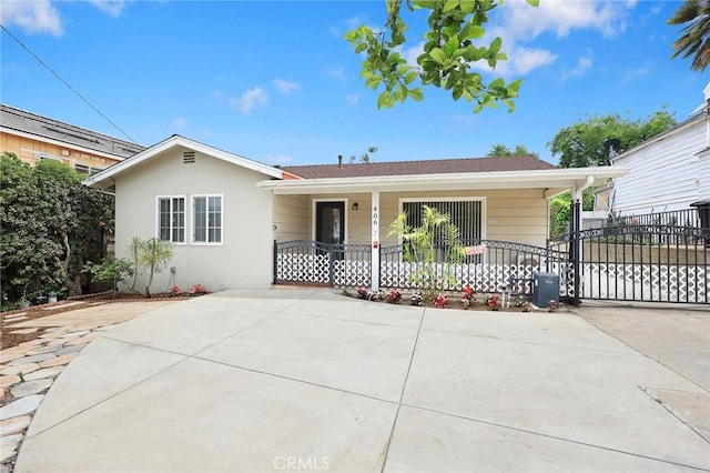 406 E Graves Ave, Monterey Park, CA 91755 - ranch-style home featuring covered porch, stucco siding, and driveway