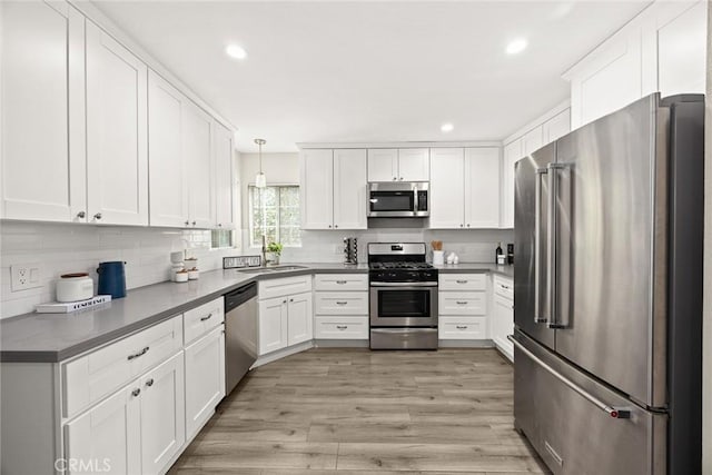 406 E Graves Ave, Monterey Park, CA 91755 - kitchen with stainless steel appliances, dark countertops, a sink, white cabinets, and recessed lighting