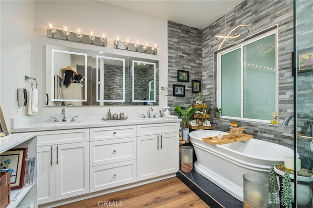 7256 Plumrose St, Fontana, CA 92336 - full bathroom featuring double vanity, a freestanding tub, and wood finished floors