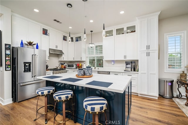 7256 Plumrose St, Fontana, CA 92336 - kitchen featuring high end refrigerator, under cabinet range hood, plenty of natural light, a center island, and recessed lighting