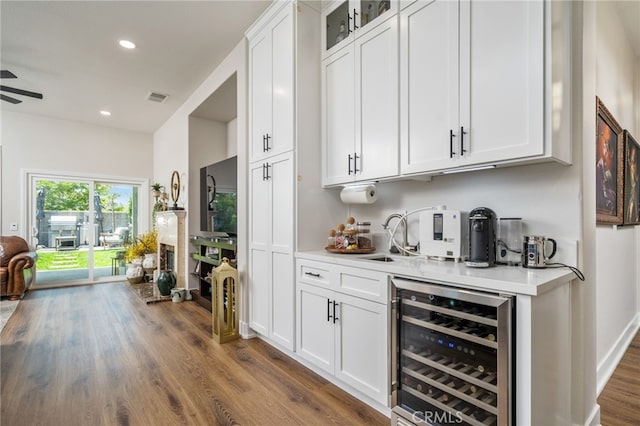 7256 Plumrose St, Fontana, CA 92336 - indoor bar with beverage cooler, dark wood-style floors, recessed lighting, and a ceiling fan
