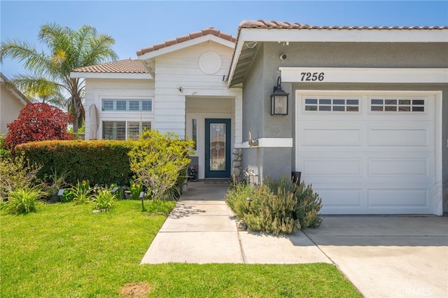7256 Plumrose St, Fontana, CA 92336 - view of front of house featuring a garage, a front lawn, a tiled roof, and stucco siding