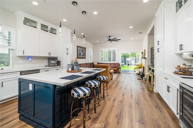 7256 Plumrose St, Fontana, CA 92336 - kitchen with beverage cooler, open floor plan, a center island, white cabinets, and recessed lighting