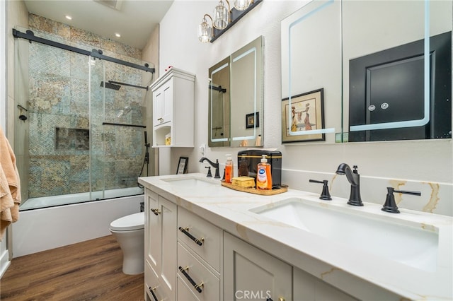 7256 Plumrose St, Fontana, CA 92336 - full bathroom with toilet, double vanity, wood finished floors, and shower / bath combination with glass door